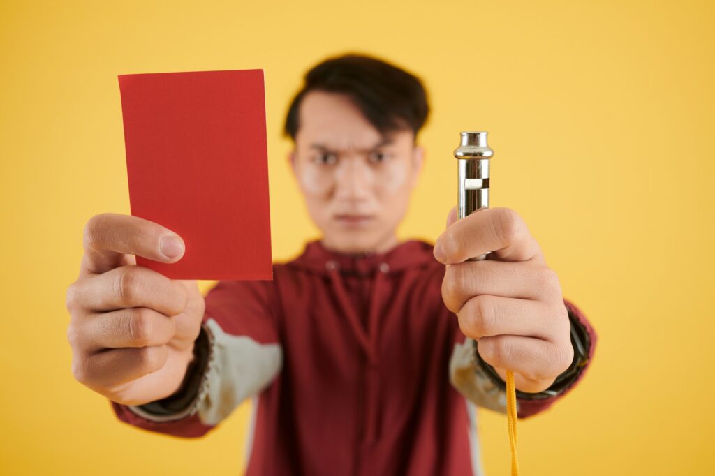 Referee Showing Red Card and Whistle
